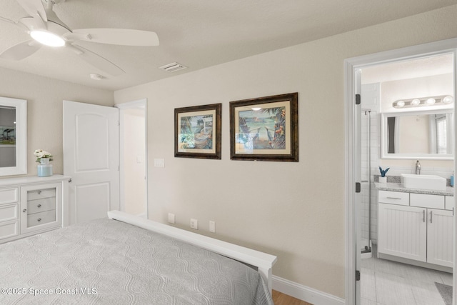 1495 Newfound Harbor Dr, Merritt Island, FL 32952 - bedroom with ceiling fan, visible vents, a sink, baseboards, and ensuite bathroom