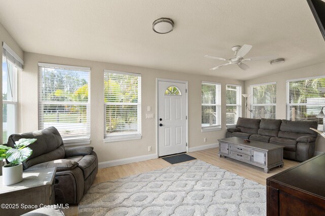 1495 Newfound Harbor Dr, Merritt Island, FL 32952 - living area featuring a ceiling fan, baseboards, a wealth of natural light, and light wood-type flooring