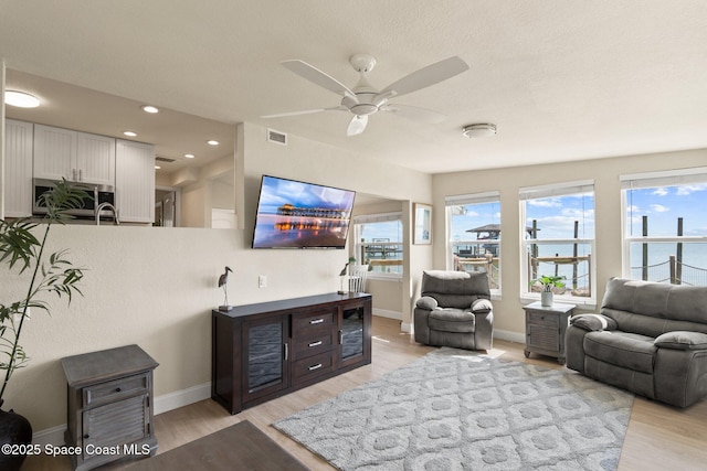 1495 Newfound Harbor Dr, Merritt Island, FL 32952 - living area featuring light wood finished floors, a ceiling fan, baseboards, recessed lighting, and visible vents