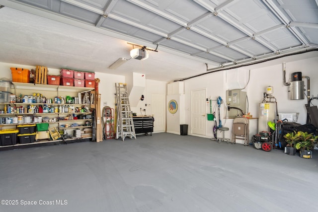 1495 Newfound Harbor Dr, Merritt Island, FL 32952 - garage featuring a garage door opener, freestanding refrigerator, and electric water heater