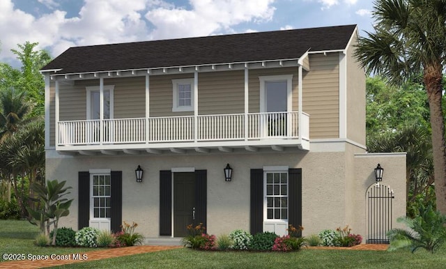 view of property featuring roof with shingles, stucco siding, and a balcony