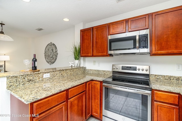53 Piney Branch Way Unit D, West Melbourne, FL 32904 - kitchen featuring visible vents, a peninsula, light stone countertops, and stainless steel appliances