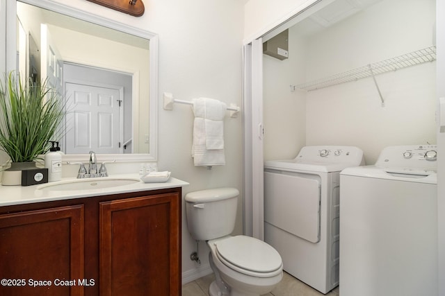 53 Piney Branch Way Unit D, West Melbourne, FL 32904 - bathroom with vanity, tile patterned flooring, washing machine and dryer, and toilet