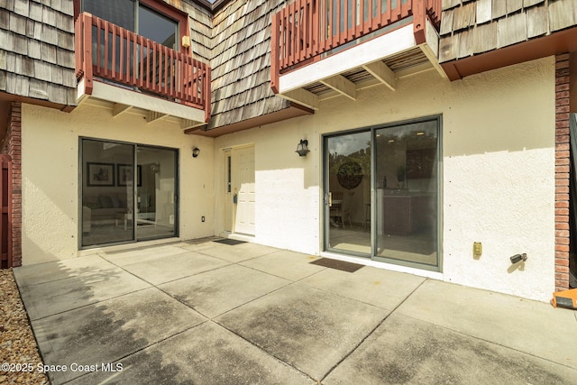 53 Piney Branch Way Unit D, West Melbourne, FL 32904 - entrance to property featuring stucco siding, mansard roof, a patio area, and a balcony