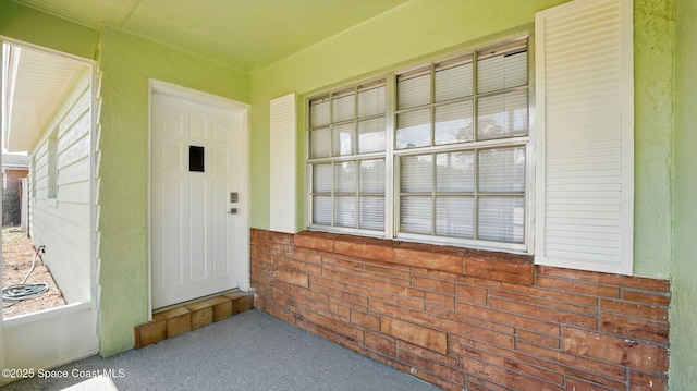 property entrance with brick siding