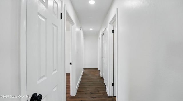corridor with recessed lighting, dark wood-style flooring, and baseboards