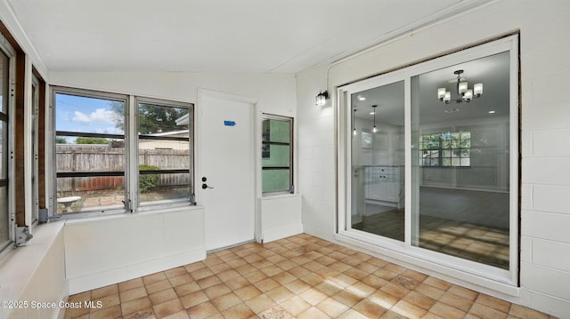 unfurnished sunroom with a chandelier and a wealth of natural light
