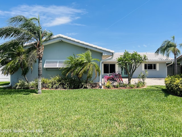 single story home with stucco siding and a front yard