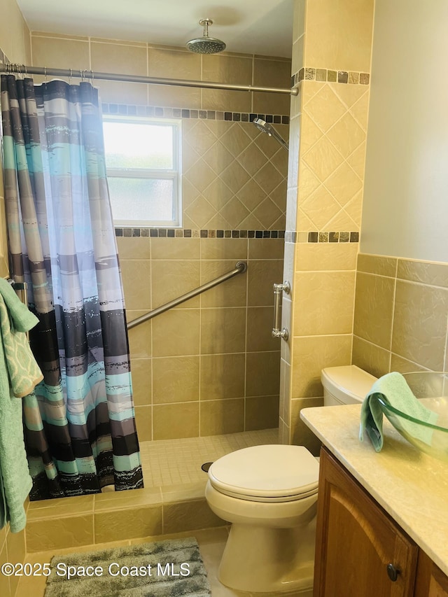 bathroom with toilet, tile walls, and a shower stall