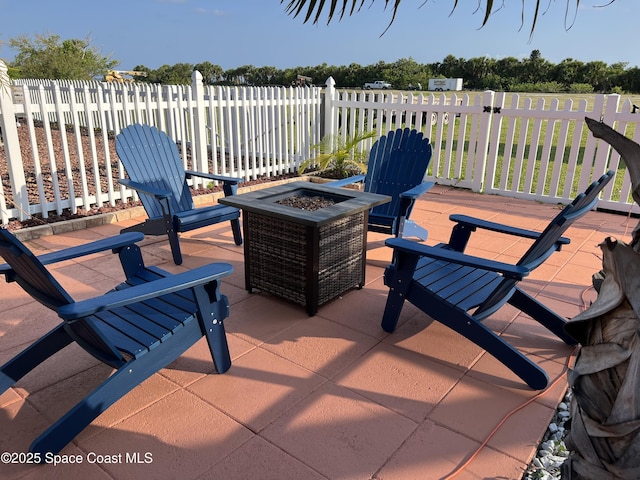view of patio / terrace featuring a fire pit and fence