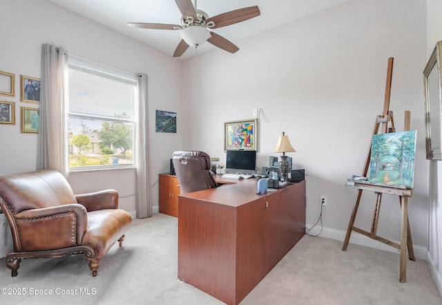 office area with baseboards, light carpet, and a ceiling fan
