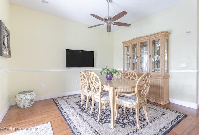 dining area with baseboards, ceiling fan, and wood finished floors