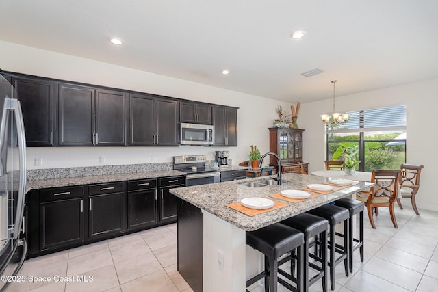 10033 W Verona Cir, Vero Beach, FL 32966 - kitchen featuring an inviting chandelier, a sink, light tile patterned floors, and stainless steel appliances
