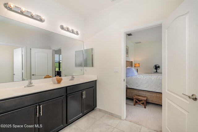 10033 W Verona Cir, Vero Beach, FL 32966 - bathroom with double vanity, a sink, ensuite bath, and tile patterned floors