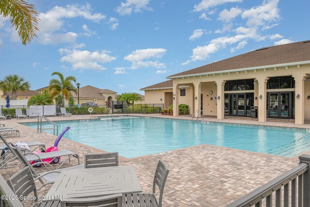 10033 W Verona Cir, Vero Beach, FL 32966 - pool featuring a patio area, fence, and french doors