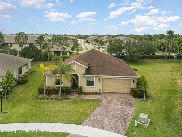 10033 W Verona Cir, Vero Beach, FL 32966 - single story home featuring a garage, a front yard, decorative driveway, stucco siding, and a residential view