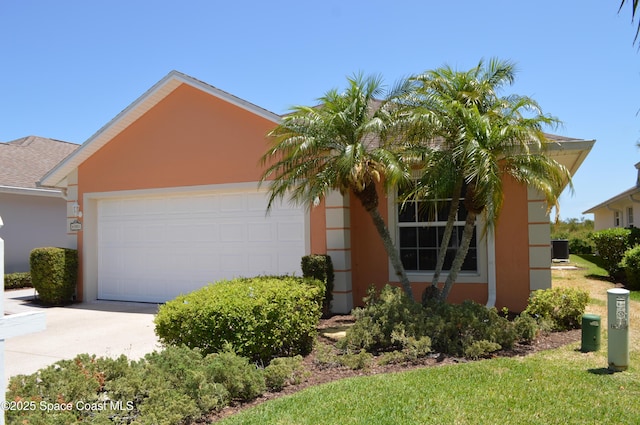 4351 Timothy Dr, Merritt Island, FL 32953 - view of front of property with a garage, cooling unit, stucco siding, and concrete driveway