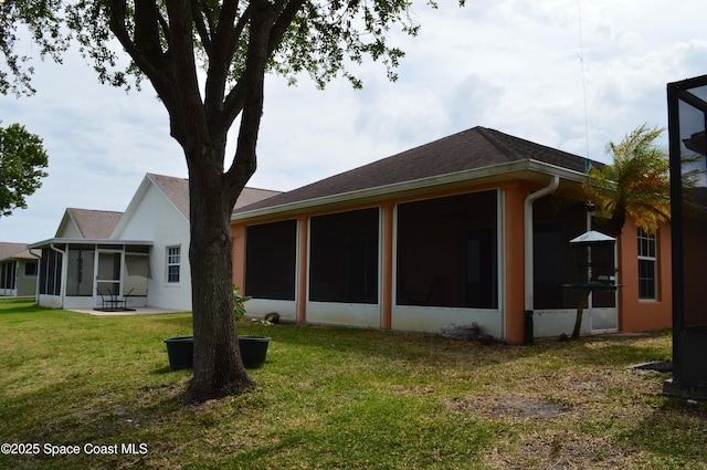 4351 Timothy Dr, Merritt Island, FL 32953 - back of house featuring a sunroom, roof with shingles, and a lawn