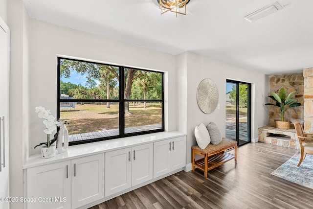 living area featuring visible vents and wood finished floors