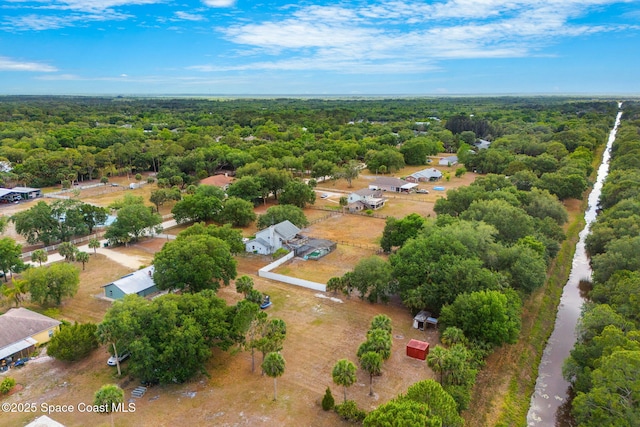 drone / aerial view with a wooded view