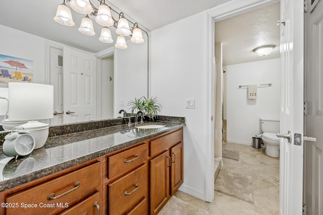 8600 Ridgewood Ave Unit 1208, Cape Canaveral, FL 32920 - bathroom with baseboards, vanity, toilet, and a textured ceiling