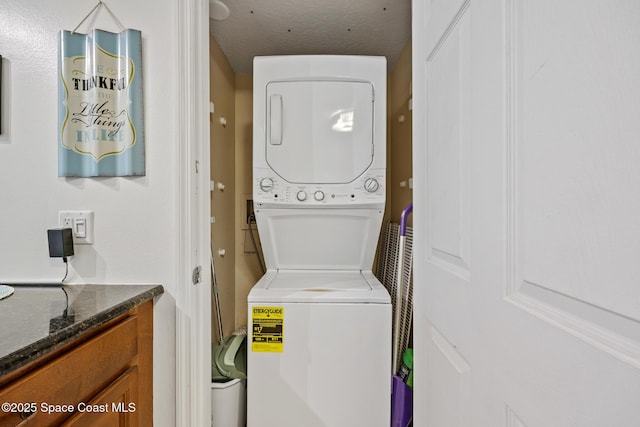 8600 Ridgewood Ave Unit 1208, Cape Canaveral, FL 32920 - laundry room featuring stacked washer and dryer and laundry area