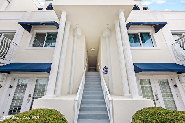 8600 Ridgewood Ave Unit 1208, Cape Canaveral, FL 32920 - view of exterior entry featuring stucco siding and french doors