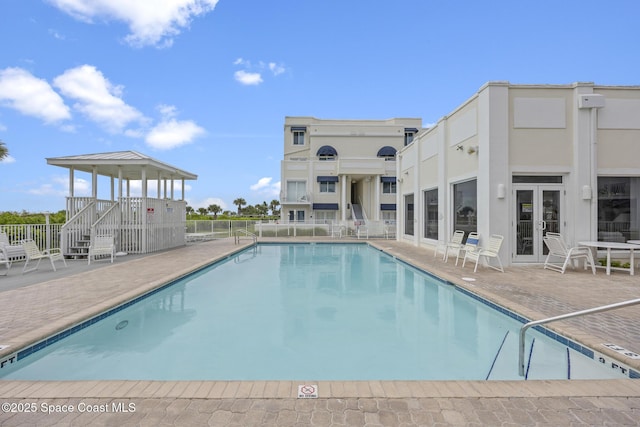8600 Ridgewood Ave Unit 1208, Cape Canaveral, FL 32920 - pool with a patio, fence, and french doors