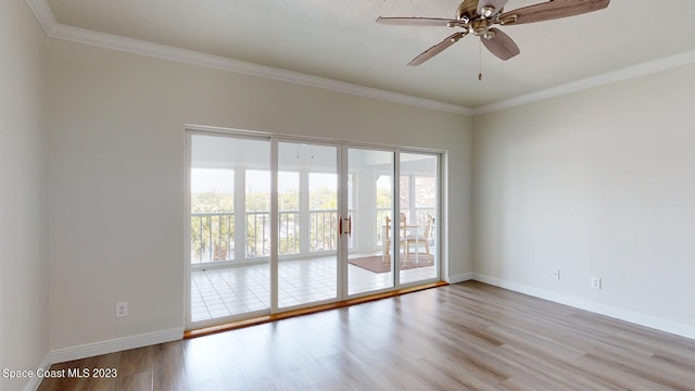 905 N Harbor City Blvd Unit 404, Melbourne, FL 32935 - empty room featuring plenty of natural light, wood finished floors, a ceiling fan, crown molding, and baseboards