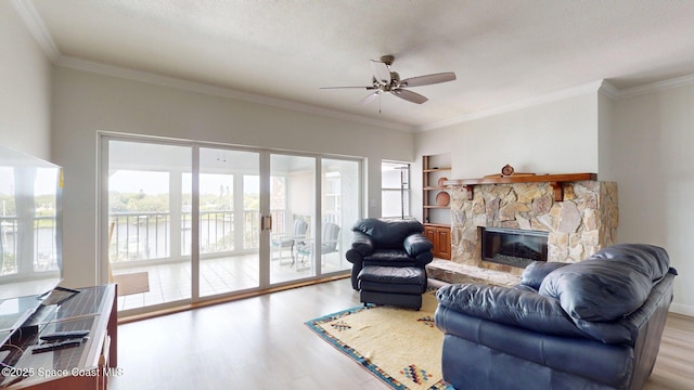 905 N Harbor City Blvd Unit 404, Melbourne, FL 32935 - living area featuring a ceiling fan, wood finished floors, a stone fireplace, crown molding, and a water view