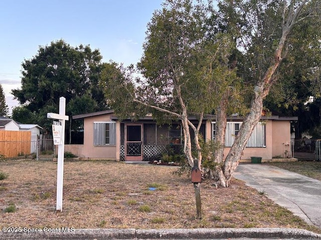 view of front of home with stucco siding and fence