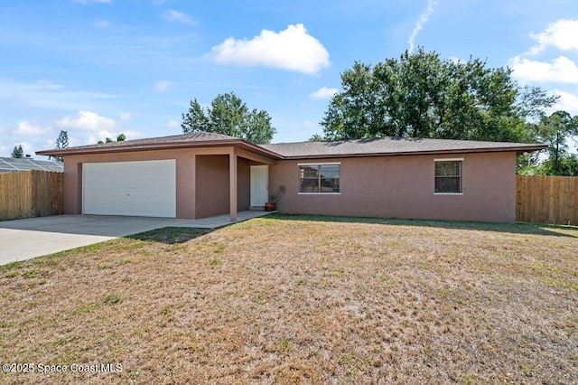 ranch-style house featuring fence, an attached garage, a front lawn, stucco siding, and driveway