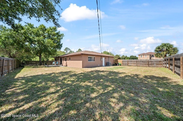 view of yard featuring central air condition unit and a fenced backyard