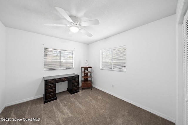 unfurnished office with carpet floors, plenty of natural light, baseboards, and ceiling fan