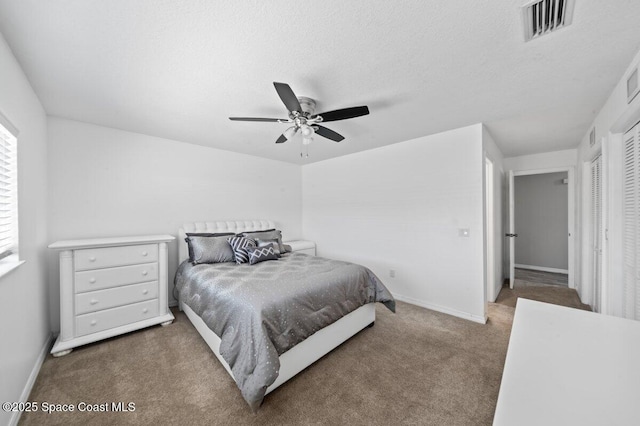 carpeted bedroom featuring visible vents, baseboards, and ceiling fan