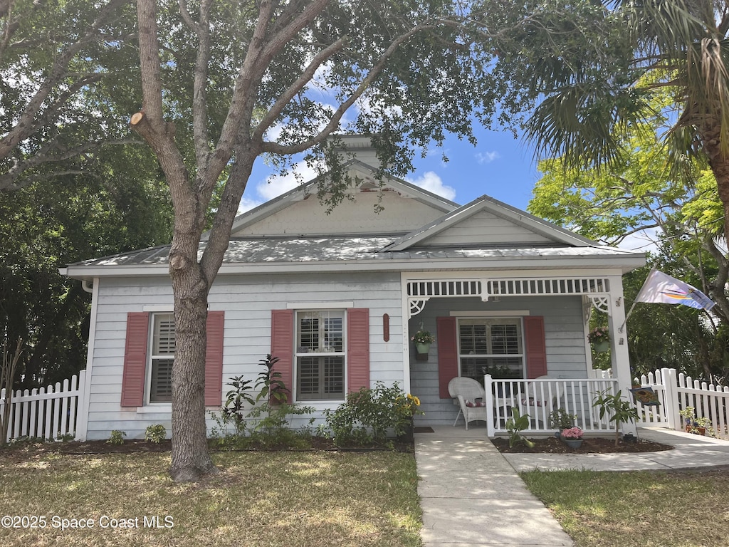 view of front of house with a porch and fence
