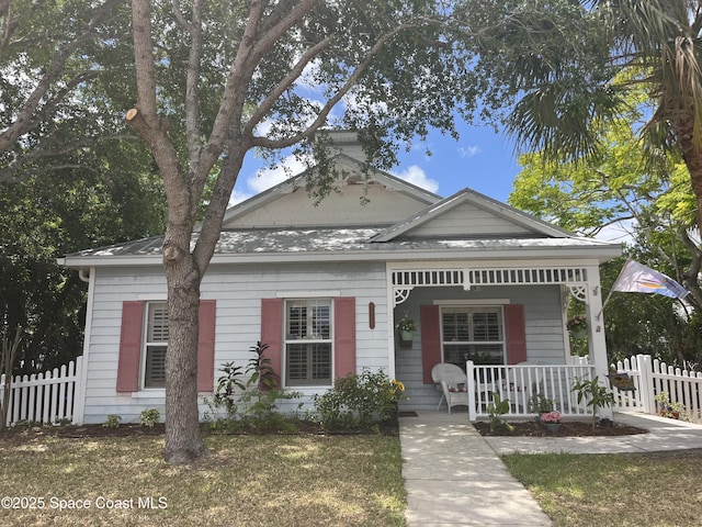 view of front of house with a porch and fence