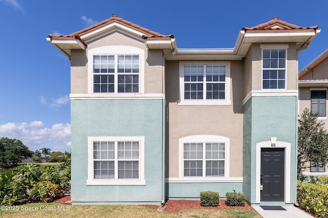 view of front of home featuring stucco siding and a tiled roof