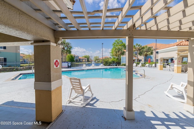 community pool featuring a patio, fence, and a pergola