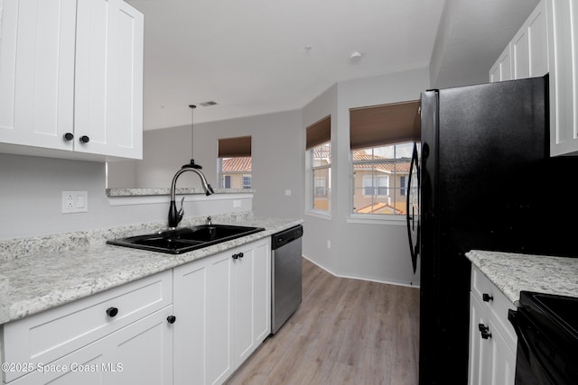 kitchen with stainless steel dishwasher, stove, light wood-type flooring, white cabinetry, and a sink