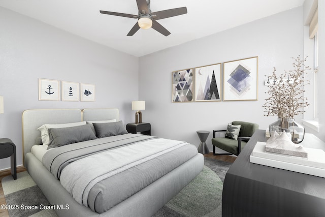 bedroom with baseboards, a ceiling fan, and wood finished floors