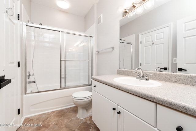 full bath featuring vanity, enclosed tub / shower combo, toilet, and visible vents