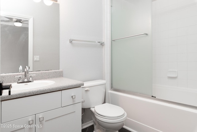 full bath featuring vanity, bath / shower combo with glass door, and toilet