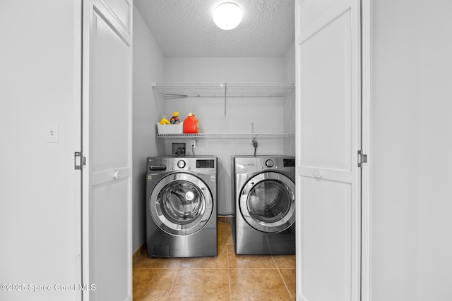 4730 Seminole Trl, Merritt Island, FL 32953 - laundry room with tile patterned floors, laundry area, a textured ceiling, and washer and clothes dryer
