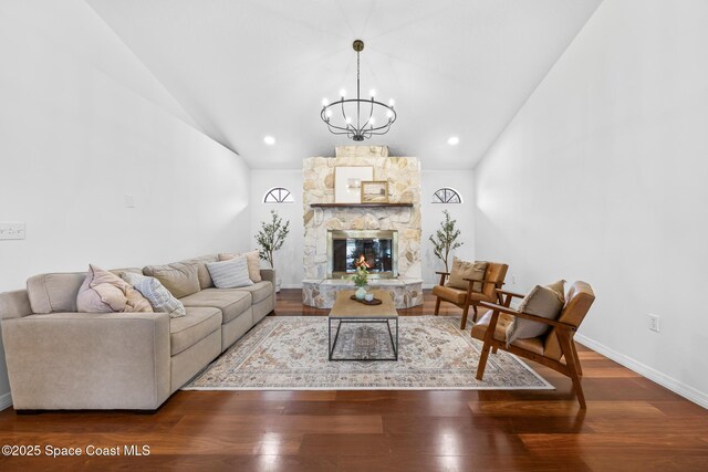4730 Seminole Trl, Merritt Island, FL 32953 - living room featuring high vaulted ceiling, a notable chandelier, a stone fireplace, and wood finished floors
