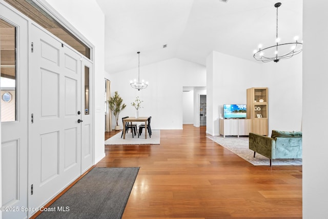4730 Seminole Trl, Merritt Island, FL 32953 - entryway with high vaulted ceiling, a notable chandelier, and wood finished floors