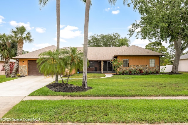 4730 Seminole Trl, Merritt Island, FL 32953 - view of front of home with a garage, a front lawn, driveway, and stone siding