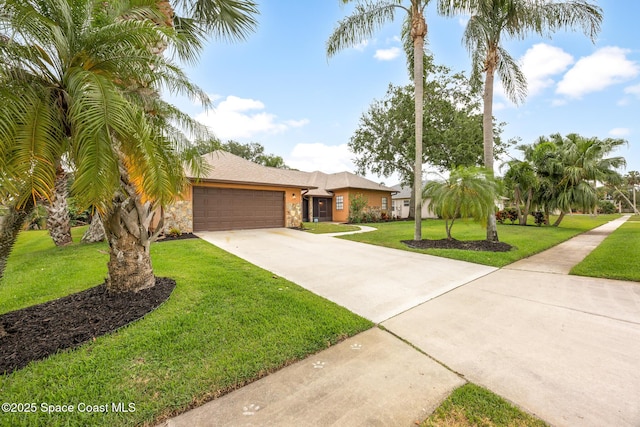 4730 Seminole Trl, Merritt Island, FL 32953 - view of front of property with an attached garage, a front lawn, stone siding, and concrete driveway