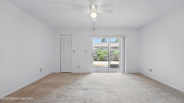 unfurnished room featuring baseboards, carpet flooring, a textured ceiling, and ceiling fan