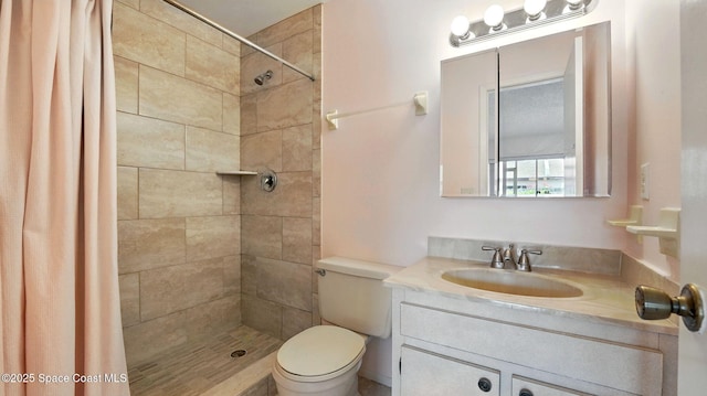 full bathroom with vanity, toilet, and tiled shower